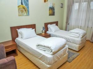 מיטה או מיטות בחדר ב-MT. Rwenzori Golf Resort & Spa