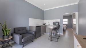 ケープタウンにあるInkantu Self-catering Apartmentsのリビングルーム(椅子付)、キッチン