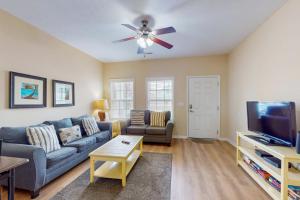 a living room with a couch and a ceiling fan at Snorkel Way in Myrtle Beach