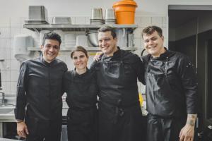 a group of three chefs standing in a kitchen at 3 VIE Restaurant & Rooms in Acquarossa