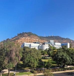 un edificio in cima a una collina con alberi di Apart Hotel AR a Santiago