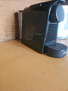 a black toaster sitting on top of a table at The Beach House Μουτσούνα Νάξος in Moutsoúna