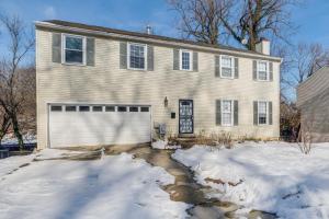 a white house with a garage in the snow at Pet-Friendly Silver Spring Home 2 Mi to Downtown! in Silver Spring