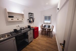 a kitchen with a sink and a red refrigerator at Tiny House mit Wohnfass in Diez