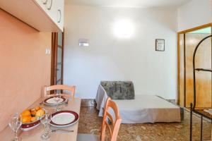 a room with a bed and a table with a bowl of fruit at PETAR in Baška Voda