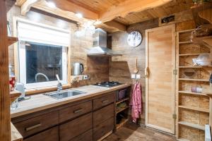 a kitchen with a sink and a stove at Chata Julie in Mařenice