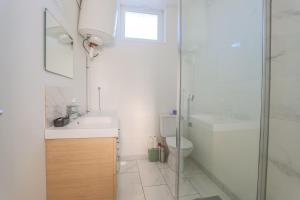 a bathroom with a sink and a toilet and a shower at Appartement Calme - Arras Arrière Gare in Arras