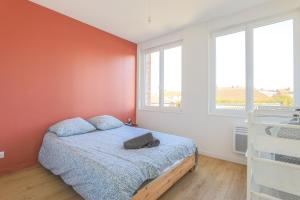 a bedroom with a bed and two windows at Appartement Calme - Arras Arrière Gare in Arras