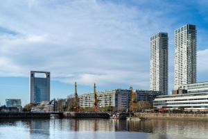 a city with tall buildings and a body of water at LV Puerto Madero in Buenos Aires
