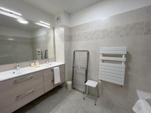a bathroom with a sink and a mirror at le Bel Alpin in Annecy +39 photos
