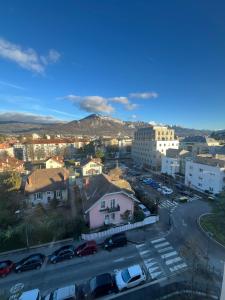 a city with cars parked in a parking lot at le Bel Alpin in Annecy