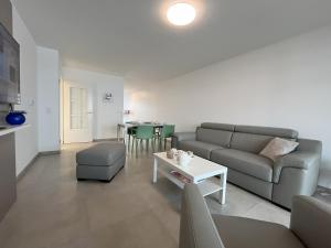 a living room with a couch and a table at le Bel Alpin in Annecy