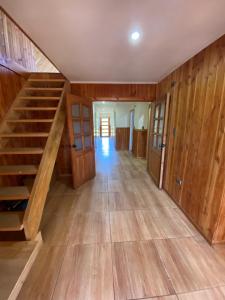 a hallway with wooden walls and stairs in a house at Casa de Campo in Osorno