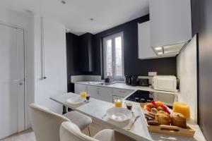 una cocina con una mesa y una bandeja de comida. en Beautiful apartment - Cozy - Near Paris, en LʼÎle-Saint-Denis