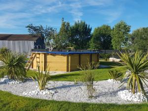 a garden with a wooden shed in a yard at La Perle de Dolitéma in Grues