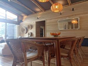 a dining room with a wooden table and chairs at Bienvenidos a su refugio Chiloé in Castro +17 photos