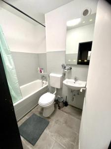 a bathroom with a white toilet and a sink at RentApart`s Nürnberg City Smart in Nuremberg