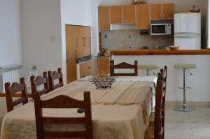 a kitchen with a table and chairs and a kitchen with a kitchen at Espacio Alem in Comodoro Rivadavia
