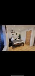 a bedroom with a bed and a wooden door at INNit Townhouse in London