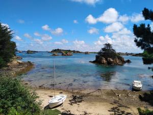 two boats sitting on the shore of a beach at chambre d'hôte proche mer in Yvias