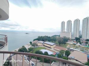 a view from a balcony of a city and the water at 17 Jazz sweet beachfront resort in Tanjung Bungah