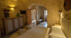 a bedroom with a bed and two towels on the floor at Masseria Morrone in Ostuni