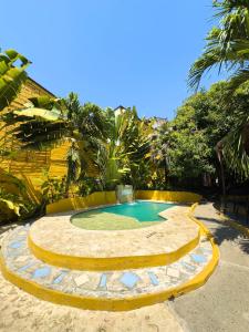 a small swimming pool in the middle of a yard at Encomendero Hotel -Centro Histórico- in Santa Fe de Antioquia