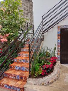 a set of stairs with flowers next to a door at Casa Amelia in San Blas