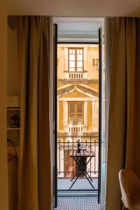 an open door with a view of a building at Le Volte And Suite in Catania