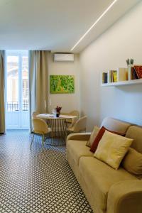 a living room with a couch and a table at Le Volte And Suite in Catania