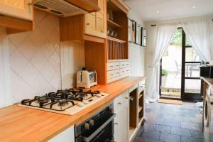 a kitchen with a stove and a counter top at Charming 2-Bed in Windsor: Walk to all the sites! in Windsor