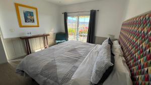 a bedroom with a large bed with a window at Santerra, Valle de Guadalupe in Valle de Guadalupe