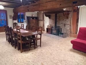 une salle à manger avec une table et une cheminée dans l'établissement A La Poularde B&B, à Curciat-Dongalon