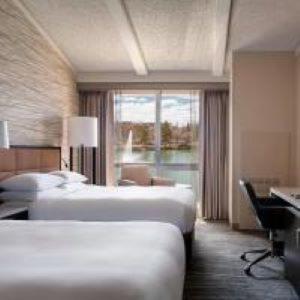 a hotel room with two beds and a desk at Lincolnshire Marriott Resort in Lincolnshire