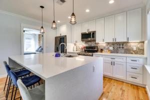 a kitchen with white cabinets and a large white island at Updated Austin Home about 1 Block to HikeandBike Trail! in Austin