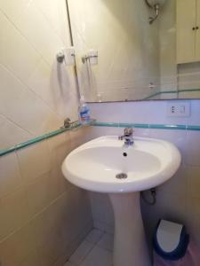 a white sink in a bathroom with a mirror at Villa Ettore in Gardeládes