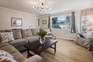 a living room with a couch and a table at North West Nest 30 Day Minimum home in Bend