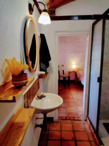 a bathroom with a sink and a mirror on the wall at Finca Emilio in Fredonia