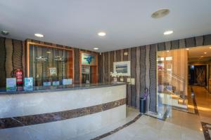 a lobby of a hotel with a counter in the lobby at Hotel Verdemar in Ribadesella