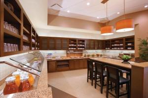a large kitchen with a large island with bar stools at Hyatt Place Chicago-South/University Medical Center in Chicago
