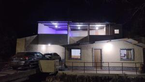 a car parked in front of a house at night at Pesque pague pousada do Carlinho in Pinheiral