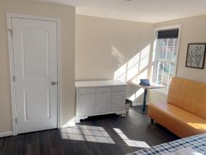 a bedroom with a bed and a desk and a window at Sweet bedroom located central of downtown in Baltimore