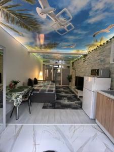 a living room with a ceiling with a ceiling fan at Studio or Panoramic Villa with hydro tube extracost in Cluj-Napoca +41 photos