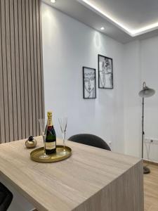 a bottle of champagne and two glasses on a table at Hella apartment in Rhodes Town