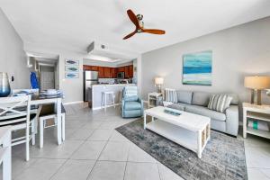 a living room with a couch and a table at Gulf Dunes 506 Hello Sunshine in Fort Walton Beach