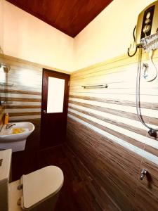 a bathroom with a toilet and a sink at Blue Surf View - Tangalle in Tangalle