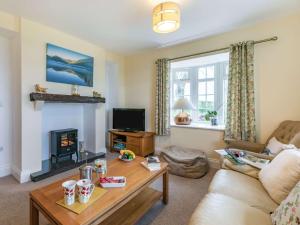 a living room with a couch and a fireplace at 3 Bed in Bridlington 56248 in Weaverthorpe