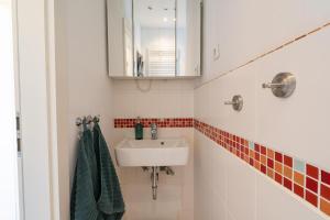 a bathroom with a sink and a mirror at Strandhafer in Norderney +2 photos