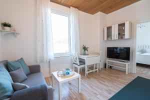 a living room with a couch and a table at Strandhafer in Norderney