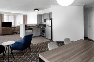 a kitchen and dining room with a table and chairs at Residence Inn White Plains Westchester County in White Plains